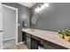 Stylish bathroom featuring a sleek vanity with marble countertop, elegant gold fixtures and modern lighting at 937 Maple Stone Dr, Greenwood, IN 46143