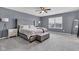 Spacious bedroom with a large bed, soft carpet, ceiling fan and a window letting in natural light at 937 Maple Stone Dr, Greenwood, IN 46143