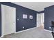 Cozy bedroom with soft gray carpet and two large white doors, complemented by the soothing blue walls at 937 Maple Stone Dr, Greenwood, IN 46143
