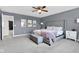 Cozy bedroom with a soft carpet, ceiling fan, and a large bed for relaxation and a stylish place to rest at 937 Maple Stone Dr, Greenwood, IN 46143