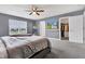 Bright bedroom featuring a ceiling fan, closet, and a TV mounted to the wall for relaxing and entertainment at 937 Maple Stone Dr, Greenwood, IN 46143