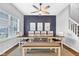 A sunlit dining room with a modern table setting, complimented by a ceiling fan at 937 Maple Stone Dr, Greenwood, IN 46143