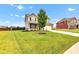 Two-story home with tidy landscaping and a well-maintained lawn extending to the sidewalk at 937 Maple Stone Dr, Greenwood, IN 46143