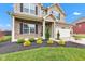 Close-up of a home's exterior, featuring brick accents and manicured landscaping at 937 Maple Stone Dr, Greenwood, IN 46143