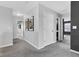 Well-lit hallway featuring neutral colors, artwork, and access to various rooms in the home at 937 Maple Stone Dr, Greenwood, IN 46143