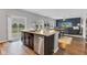 Bright kitchen with stainless steel appliances, a center island, and an open view of the backyard at 937 Maple Stone Dr, Greenwood, IN 46143
