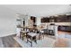 Modern kitchen featuring dark cabinets, an island with bar seating, and an adjacent dining area at 937 Maple Stone Dr, Greenwood, IN 46143