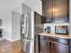Modern kitchen with stainless steel refrigerator, dark cabinets, and sleek countertops at 937 Maple Stone Dr, Greenwood, IN 46143