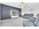 Comfortable living room with a mounted TV, a gray couch, and a ceiling fan at 937 Maple Stone Dr, Greenwood, IN 46143