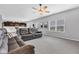 Bright living area featuring a cozy sectional sofa, large windows, and a ceiling fan at 937 Maple Stone Dr, Greenwood, IN 46143