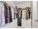 A walk-in closet featuring a rack for hanging and shelves for shoes and folded clothing items at 937 Maple Stone Dr, Greenwood, IN 46143