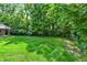 A lush green backyard features a well-maintained lawn, tall trees, and manicured landscaping, offering a serene retreat at 9650 Copley Dr, Carmel, IN 46290