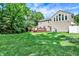 Lush backyard featuring a well-manicured lawn, charming deck, and the home's exterior for tranquil outdoor enjoyment at 9650 Copley Dr, Carmel, IN 46290