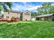 Beautiful backyard with lush green lawn, deck, shed, and the home's rear facade, creating a serene outdoor space at 9650 Copley Dr, Carmel, IN 46290
