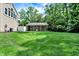 Backyard view showcasing a well-maintained lawn, outbuilding, and the house's rear, perfect for outdoor activities at 9650 Copley Dr, Carmel, IN 46290