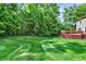 Green backyard featuring an inviting deck and mature trees, offering a private outdoor space at 9650 Copley Dr, Carmel, IN 46290