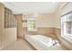 Well-lit bathroom featuring a tub, a shower, and tiled walls at 9650 Copley Dr, Carmel, IN 46290