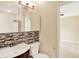 Bathroom featuring updated vanity with mosaic backsplash, modern faucet, vanity mirror, and a toilet at 9650 Copley Dr, Carmel, IN 46290