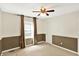 This bedroom features neutral walls, carpet floors, a ceiling fan, and a window with curtains for natural light at 9650 Copley Dr, Carmel, IN 46290