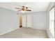 Bedroom featuring gray walls, carpeted floors, a ceiling fan, and an open doorway to other rooms at 9650 Copley Dr, Carmel, IN 46290