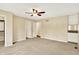 Spacious bedroom featuring a ceiling fan, carpeted floors, and a built-in wet bar area for convenience at 9650 Copley Dr, Carmel, IN 46290