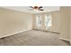 Neutral bedroom featuring a ceiling fan, two windows providing natural light and carpeted flooring at 9650 Copley Dr, Carmel, IN 46290