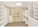 Bright walk-in closet with custom shelves and drawers at 9650 Copley Dr, Carmel, IN 46290