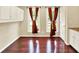 Charming dining area with hardwood floors, and bright windows dressed with beautiful red patterned curtains at 9650 Copley Dr, Carmel, IN 46290