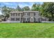 Inviting home with a well-manicured lawn, classic shutters, and surrounded by mature trees at 9650 Copley Dr, Carmel, IN 46290