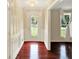 Bright foyer with hardwood floors, paneled walls, and a decorative glass front door at 9650 Copley Dr, Carmel, IN 46290
