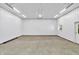 Spacious garage featuring ample lighting, concrete floor, and metal walls, offering a functional and durable workspace at 9650 Copley Dr, Carmel, IN 46290