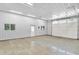 Interior of a large garage with concrete floors and white metal walls, ready for vehicles or workspace at 9650 Copley Dr, Carmel, IN 46290
