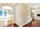 Hallway with hardwood floors leading to a sunroom and fireplace, full of natural light at 9650 Copley Dr, Carmel, IN 46290