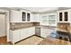 The kitchen features a stainless steel dishwasher, granite countertops, and tile backsplash at 9650 Copley Dr, Carmel, IN 46290