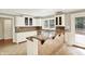 Kitchen area featuring granite countertops, stainless steel dishwasher, and access to the outdoor deck at 9650 Copley Dr, Carmel, IN 46290