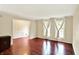 Bright living room with hardwood floors and large windows dressed with light draperies at 9650 Copley Dr, Carmel, IN 46290