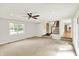 Bright living room with plush carpet, a ceiling fan, and an abundance of natural light at 9650 Copley Dr, Carmel, IN 46290