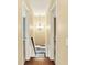 Upper level hallway with hardwood flooring, decorative light fixture, and access to multiple bedrooms at 9650 Copley Dr, Carmel, IN 46290
