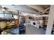 Unfinished basement with exposed beams and brick, providing ample storage and laundry area with washer and dryer at 1002 N New Jersey St, Indianapolis, IN 46202
