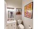 Bright bathroom featuring a white vanity with sink and toilet with bidet, complemented by artwork on the walls at 1002 N New Jersey St, Indianapolis, IN 46202