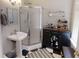 This bathroom includes a standing shower, updated fixtures, and black and white checkered flooring at 1002 N New Jersey St, Indianapolis, IN 46202