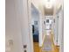 Hallway with hardwood floors leading to a bright living room and kitchen area at 1002 N New Jersey St, Indianapolis, IN 46202