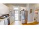 A bright kitchen area with stainless steel appliances, white cabinetry, and an adjacent doorway to the outside at 1002 N New Jersey St, Indianapolis, IN 46202