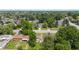 An aerial view displays a well-maintained residential area with manicured lawns, tree coverage, and street access at 1020 N Ritter Ave, Indianapolis, IN 46219