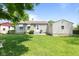 Landscaped backyard featuring a well-maintained lawn and detached garage at 1020 N Ritter Ave, Indianapolis, IN 46219