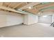 Large unfinished basement space with exposed ceiling and painted walls, offering potential at 1020 N Ritter Ave, Indianapolis, IN 46219