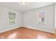 Bright bedroom with two windows, hardwood floors, and neutral walls at 1020 N Ritter Ave, Indianapolis, IN 46219