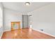 Bright bedroom with a mirrored shelf, hardwood floors, and doors to a hall at 1020 N Ritter Ave, Indianapolis, IN 46219