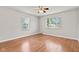 Bright bedroom featuring hardwood floors, a ceiling fan, and a window with natural light at 1020 N Ritter Ave, Indianapolis, IN 46219