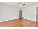 Spacious bedroom with wood floors, ceiling fan, and doors leading to a hall and closet at 1020 N Ritter Ave, Indianapolis, IN 46219